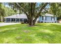 Beautiful home with a sprawling green lawn, and mature trees, offering a sense of privacy and tranquility at 9642 Florida Boys Ranch Rd, Clermont, FL 34711