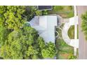 Aerial view of a private home showcasing mature trees, a swimming pool, and circular driveway at 1148 Northcrest Dr, Apopka, FL 32703