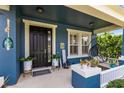 Charming front porch featuring cozy seating, decorative plants, and a welcoming entrance at 11850 Sheltering Pine Dr, Orlando, FL 32836