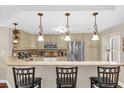 Well-equipped kitchen with granite countertops, stainless steel appliances and pendant lighting above the bar at 1217 Salerno Ct # 1217, Orlando, FL 32806