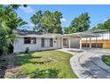 Inviting single-story home featuring a carport, walkway, and well-kept lawn at 1308 Oregon St, Orlando, FL 32803