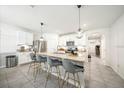 Bright kitchen featuring a large island, modern appliances, and stylish pendant lighting at 133 Hickory Course Circle, Ocala, FL 34472