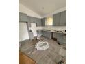 Spacious kitchen featuring modern gray cabinets, countertops, and stainless appliances at 134 W Northside Dr, Lake Wales, FL 33853