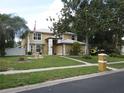 Charming two-story home features manicured lawn, mature trees, and a welcoming front entrance at 1420 Center St, Ocoee, FL 34761