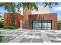 Contemporary home featuring distinctive wood siding and artistic driveway, enhanced by lush greenery at 1742 Temple Dr, Winter Park, FL 32789