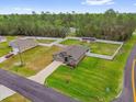 An aerial view of a home with a spacious yard, surrounded by a white fence and lush greenery at 17485 Sw 36Th Ter, Ocala, FL 34473