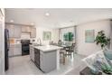 Modern kitchen with gray cabinets, island, and stainless steel appliances at 214 Oak Lane Rd, Ocala, FL 34472