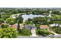 This aerial view showcases the home's proximity to a serene lake and lush greenery at 2154 Lake Christie Dr, Orlando, FL 32809