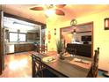 Inviting dining room featuring wood floors and a clear view into the kitchen at 2154 Lake Christie Dr, Orlando, FL 32809