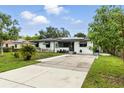 This inviting home with solar panels features a well-maintained lawn and a welcoming entrance at 2154 Lake Christie Dr, Orlando, FL 32809