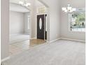 Inviting entryway with tiled flooring, leading to a spacious living area with neutral-toned walls and plush carpet at 2315 Black Lake Blvd, Winter Garden, FL 34787