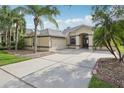 Spacious home featuring a two-car garage and a wide driveway, complemented by lush landscaping at 2315 Black Lake Blvd, Winter Garden, FL 34787