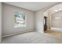 Bright living room with large windows, plush carpeting, and an open layout leading to the entryway at 2315 Black Lake Blvd, Winter Garden, FL 34787