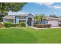 Well-maintained single-story home featuring a lush green lawn and carefully trimmed hedges at 2674 Sugar Pine Run, Oviedo, FL 32765