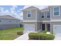 Desirable townhome with a single-car garage and well-maintained lawn at 275 Blueberry Ln, Davenport, FL 33837