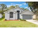 Charming single-Gathering home featuring a two-car garage, arched windows and landscaped front yard at 2767 Aragon Ter, Lake Mary, FL 32746