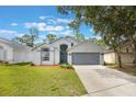 Charming single-Gathering home featuring a two-car garage, arched windows and landscaped front yard at 2767 Aragon Ter, Lake Mary, FL 32746