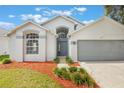 Charming single-Gathering home featuring a two-car garage, arched windows and landscaped front yard at 2767 Aragon Ter, Lake Mary, FL 32746