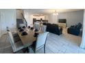Open-concept living and dining area featuring modern tile flooring and abundant natural light at 2855 Bookmark Dr, Kissimmee, FL 34746