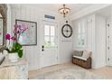 Bright entryway with tile floors, wall art, and a decorative bench at 3309 Hill St, New Smyrna Beach, FL 32169