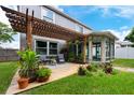 Inviting backyard with a wooden pergola, deck and a charming sunroom at 415 Eastbridge Dr, Oviedo, FL 32765