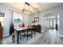 Elegant dining room with modern light fixture, stylish decor and wood laminate floors at 415 Eastbridge Dr, Oviedo, FL 32765