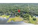 Serene aerial view of the property surrounded by lush greenery, lake, and waterfront at 419 Whitcomb Dr, Geneva, FL 32732