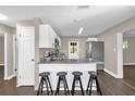 Well-appointed kitchen with white cabinetry, granite countertops, and bar stool seating at 461 Brentwood Dr, Daytona Beach, FL 32117
