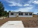 Charming single-story home with an unfinished front yard and concrete driveway at 4720 Oak St, Fruitland Park, FL 34731