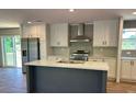 Modern kitchen featuring an island, stainless steel appliances, and white cabinetry at 4720 Oak St, Fruitland Park, FL 34731