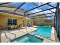 Spacious screened-in pool area with comfortable lounge chairs and an adjacent outdoor dining space at 5368 Oakbourne Ave, Davenport, FL 33837