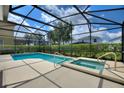 Inviting screened-in pool and spa area, perfect for relaxation and outdoor fun at 5368 Oakbourne Ave, Davenport, FL 33837