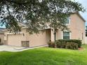 Side view of a charming two-story home with a well-maintained lawn at 5917 Coquyt Dr, Mount Dora, FL 32757