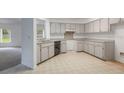 Clean kitchen with ample counter space, white cabinetry, and stainless steel appliances at 5990 Se 5Th Pl, Ocala, FL 34472