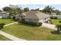 Well-kept home featuring a lush lawn and mature greenery at 710 Independence Dr, Orange City, FL 32763