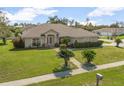 Inviting home with a lush lawn and manicured shrubbery at 710 Independence Dr, Orange City, FL 32763