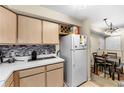 Kitchen features modern appliances, countertop, and a wine rack at 829 Camargo Way # 211, Altamonte Springs, FL 32714