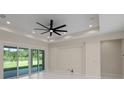 Bright living room featuring recessed lighting, a modern ceiling fan, and large glass doors at 10 Dial Ave, Debary, FL 32713