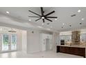 Bright living room featuring recessed lighting, a modern ceiling fan, and french doors at 10 Dial Ave, Debary, FL 32713
