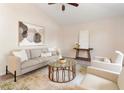 Cozy living room featuring a neutral color palette, comfortable seating, and an elegant glass-top coffee table at 1154 Feather Dr, Deltona, FL 32725