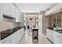 Bright kitchen featuring white cabinets, black countertops, modern appliances, and breakfast nook with bay window at 1225 Hollow Pine Dr, Oviedo, FL 32765