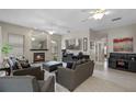 Spacious living room with a fireplace, comfortable seating, and ample natural light, perfect for relaxation and entertaining at 1225 Hollow Pine Dr, Oviedo, FL 32765