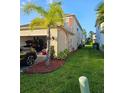 Exterior showing a well-maintained yard, two-car garage and a side yard at 1259 Pando Loop, Orlando, FL 32824