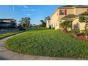 Well maintained two-story home featuring a lush green lawn and manicured landscaping at 1259 Pando Loop, Orlando, FL 32824