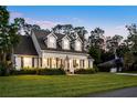 Attractive home with a wide front lawn, covered porch and tidy landscaping set beneath mature trees at 1443 Stone Trl, Enterprise, FL 32725