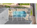 Bird's eye view of screened pool, surrounded by brick patio, greenery, and partial house view at 1455 Royal Forest Loop, Lakeland, FL 33811