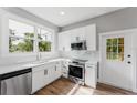 Well-lit kitchen showcases white cabinetry, stainless steel appliances, and modern countertops at 1480 Wauchula St, Intercession City, FL 33848