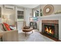 Cozy living room with fireplace, modern decor, and hardwood floors at 1600 Dauphin Ln, Orlando, FL 32803