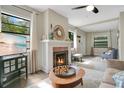 Bright living room featuring a fireplace, hardwood floors, and large windows at 1600 Dauphin Ln, Orlando, FL 32803