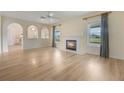 Bright living room with fireplace, new hardwood floors, arches and natural light from the windows at 16243 Wilkinson Dr, Clermont, FL 34714